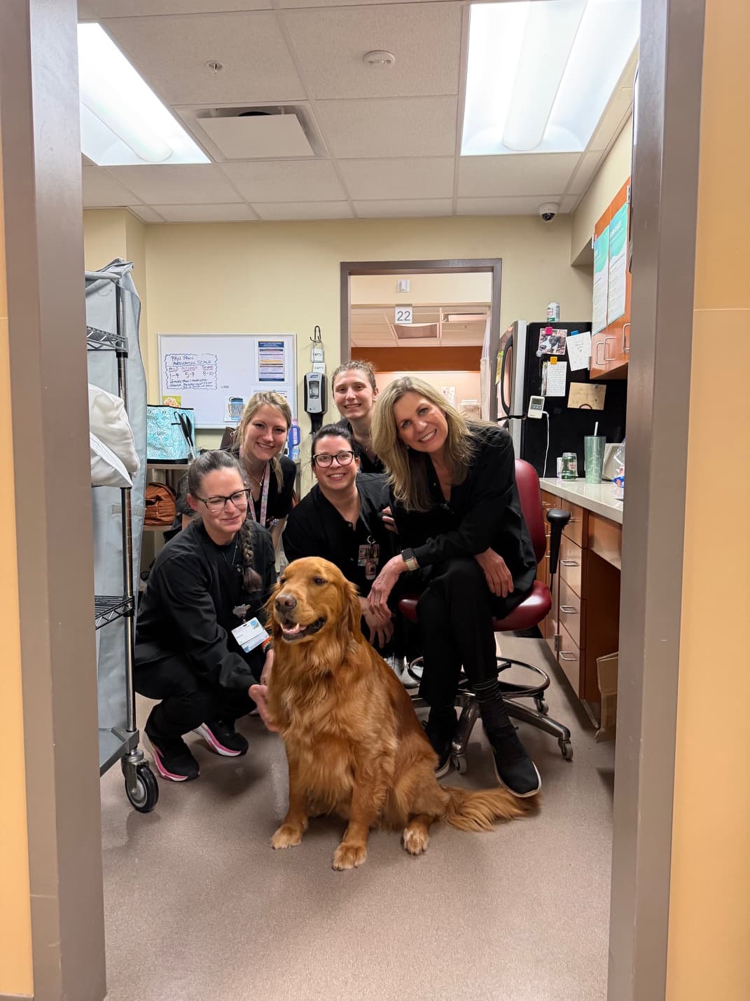 Rosco seated with members of the office team